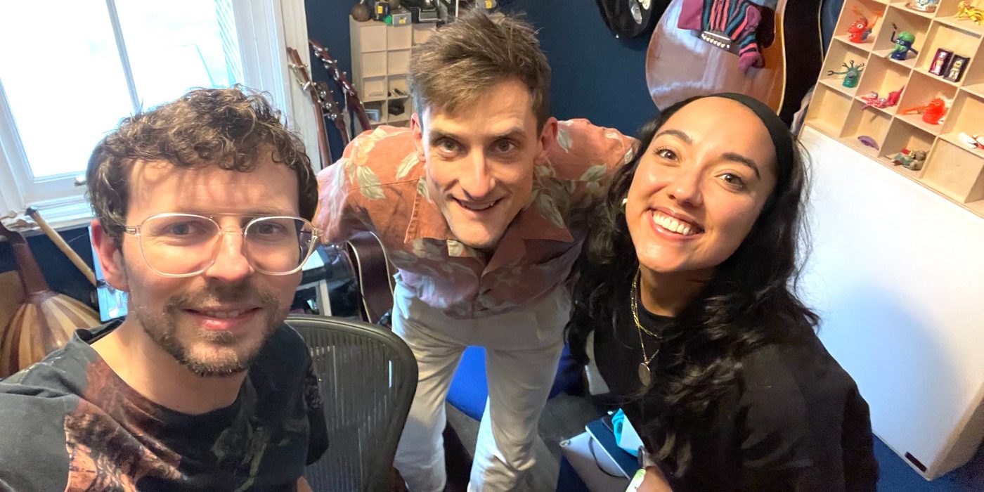 Dom James and Tommy Antonio with Grace Mouat in their studio, surrounded by guitars and percussion